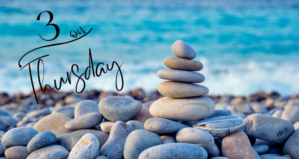 stacked stones on a beach with blue ocean in the background and the words 3 on Thursday 